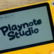 A small yellow handheld with a "Playnote Studio" graph displayed on its screen.